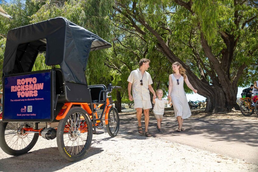 A family walking beside a ROTTOWICK TOUR vehicle. 1