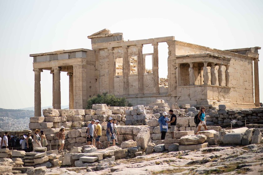 Ancient ruins with columns and visitors. 4