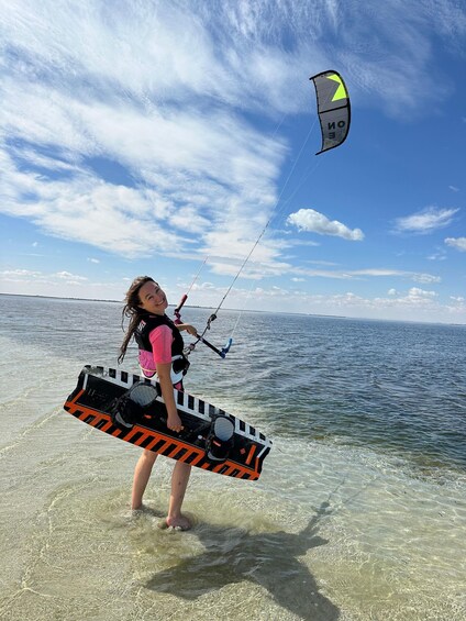 A person kiteboarding on a clear day over a body of water. 2