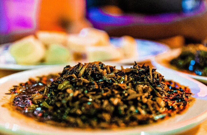 A plate of stir-fried vegetables with a sauce. 2