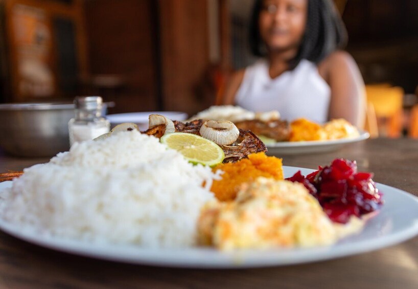 A plate of food with rice, meat, and vegetables. 1