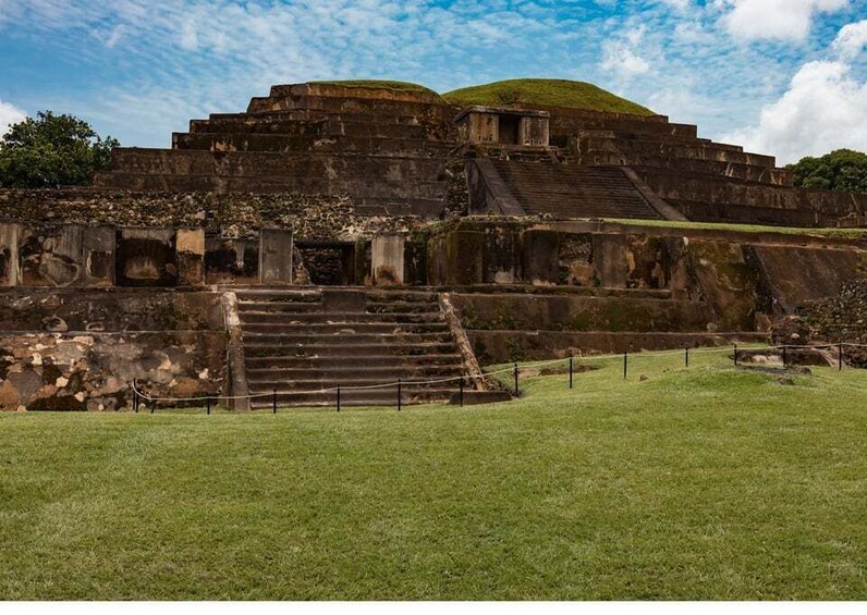 Ancient ruins with a large staircase leading up to a platform. 3