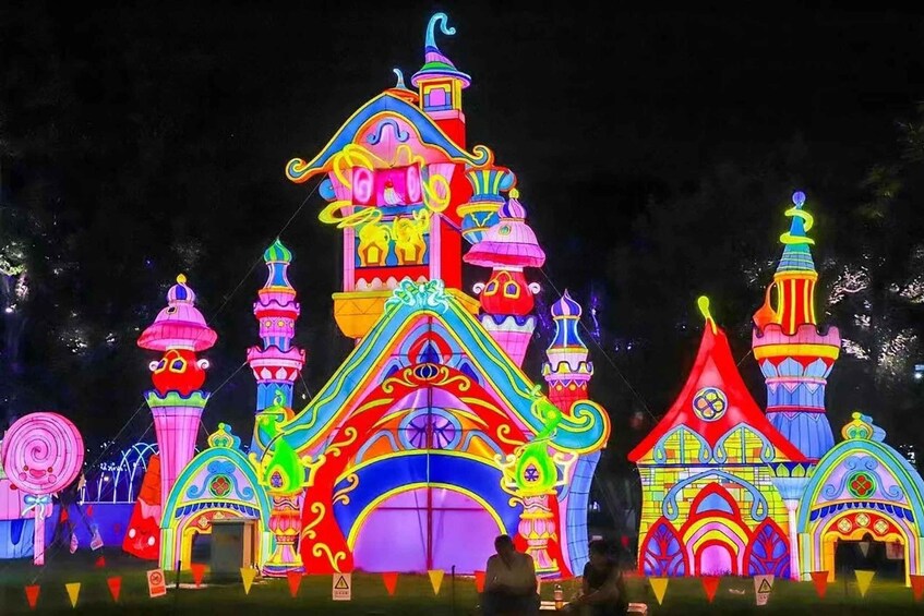 A brightly lit, colorful building with multiple towers and domes. 1