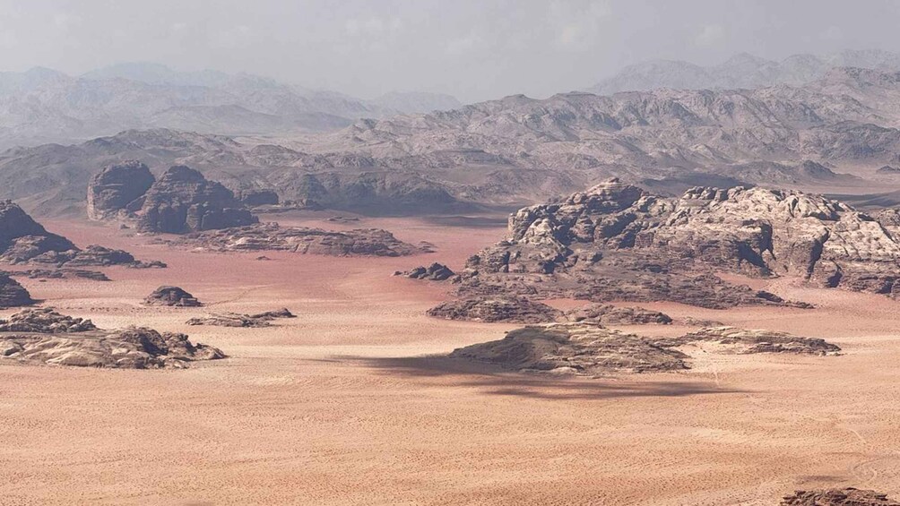 A desert landscape with rocky formations and distant mountains. 2