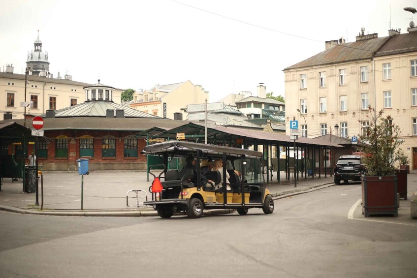 A yellow trolley with passengers, a no entry sign, and a blue parking sign on a city street. 3