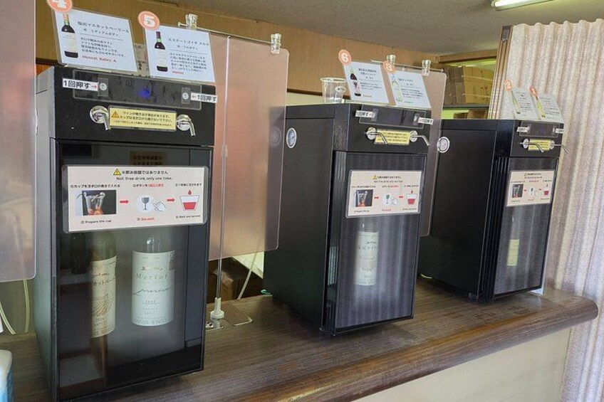Three beverage dispensers with instructions and warnings on a counter. 3