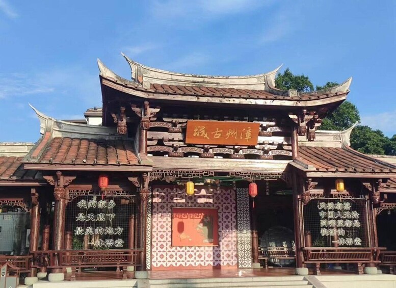 A traditional Chinese building with ornate architecture, including curved roofs and intricate wooden carvings. 4