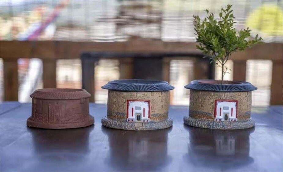 Three miniature houses with different roof designs on a table. 5