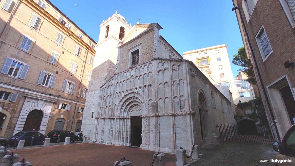 A historic church with a bell tower, surrounded by urban buildings. 3