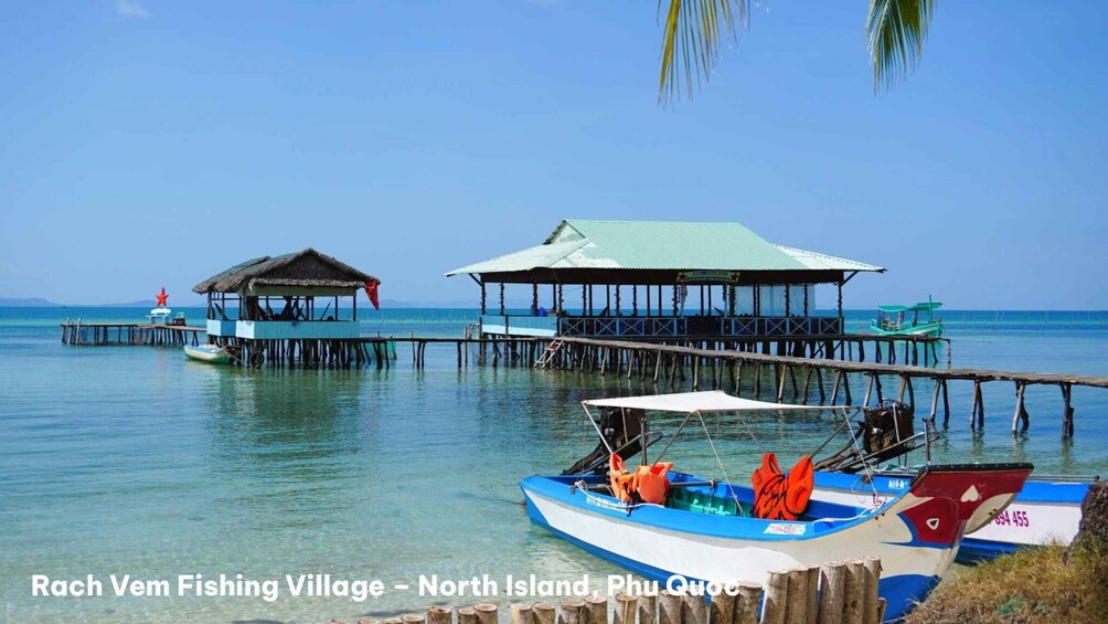 A fishing village with wooden structures and boats on a calm sea. 5