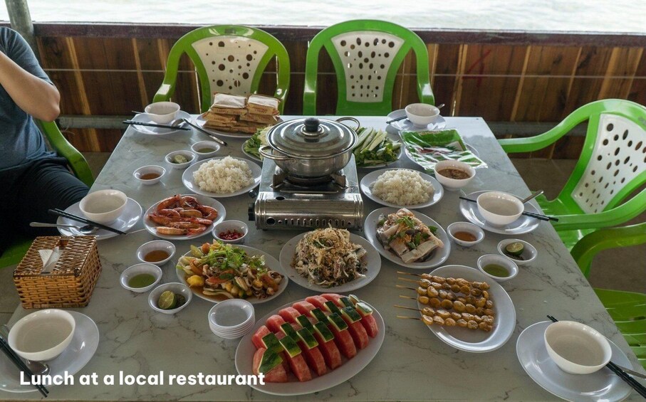 A table set for lunch at a local restaurant with various dishes and condiments. 2