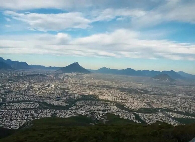A cityscape with mountains in the background. 1