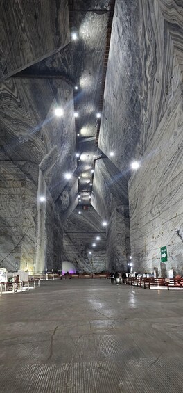A large indoor space with high ceilings and marble walls. 1