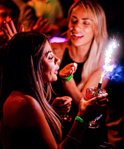 A person holding a lit sparkler. 3