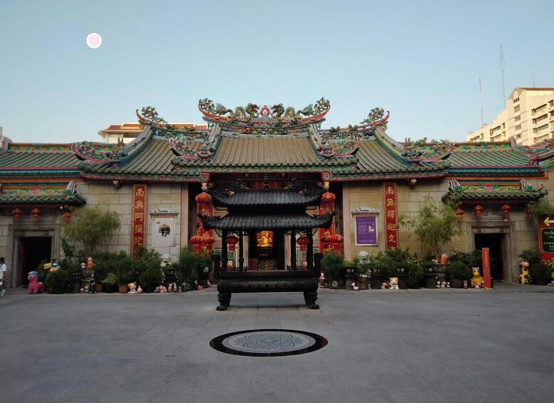 A traditional Chinese building with ornate architecture, a central pavilion, and red lanterns. 5