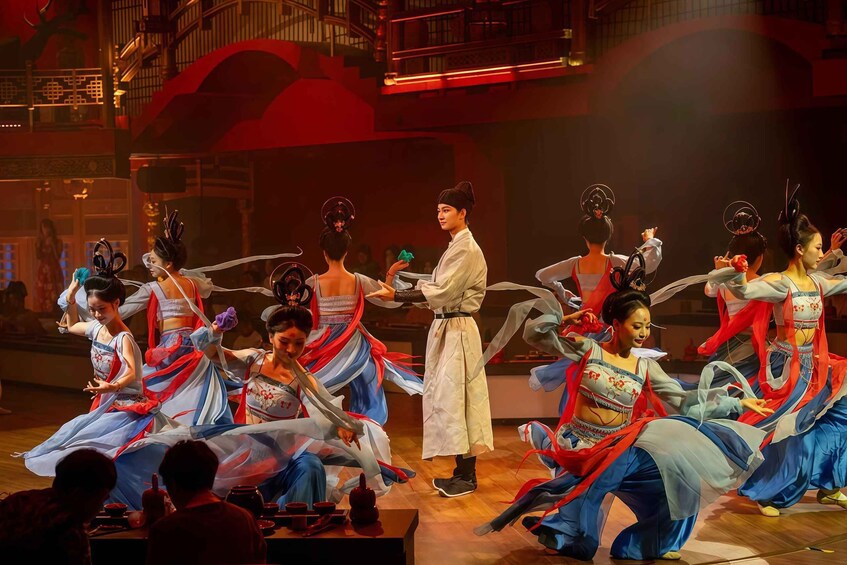 A traditional dance performance with dancers in elaborate costumes. 1