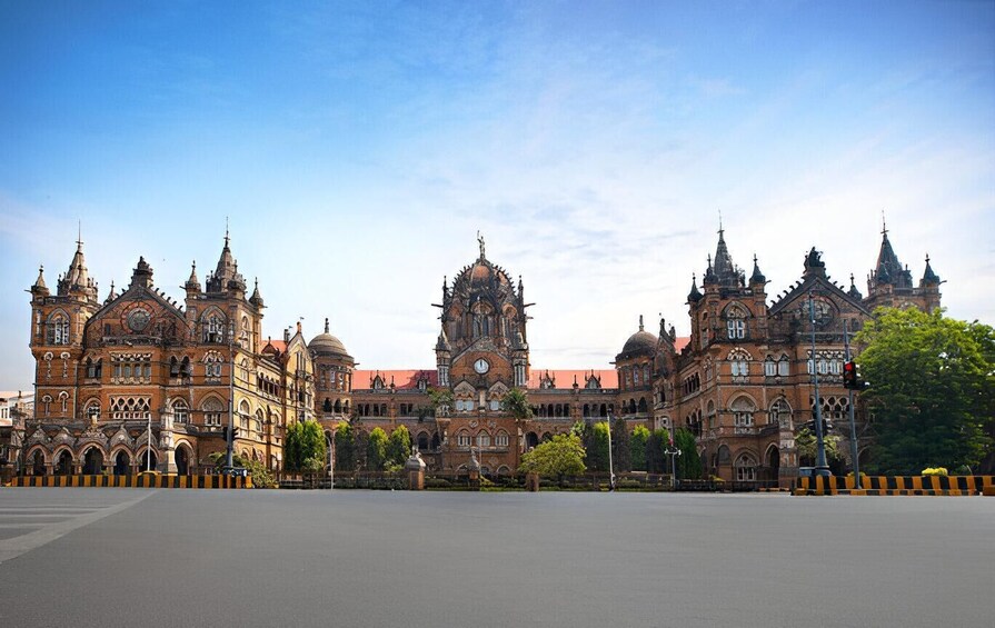 A large, ornate building with multiple spires and domes, surrounded by a paved area and trees. 5