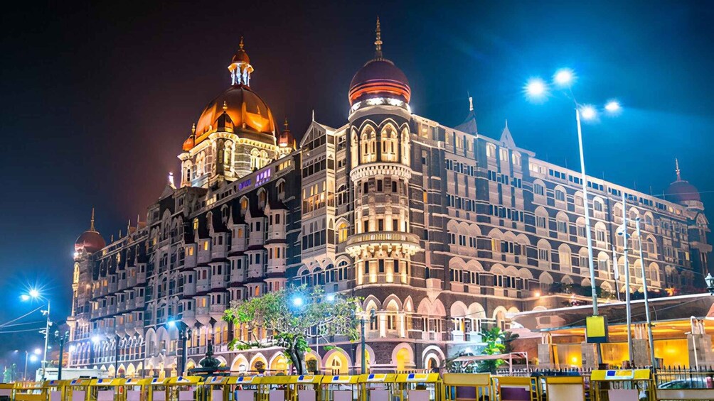 A grand, illuminated building with domed structures and ornate architecture. 3