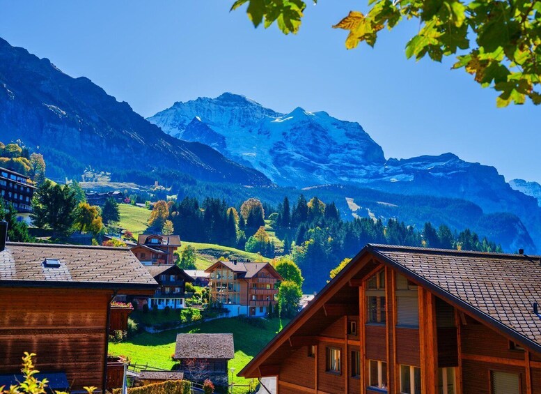 A mountain village with wooden houses and a view of snow-capped peaks. 5