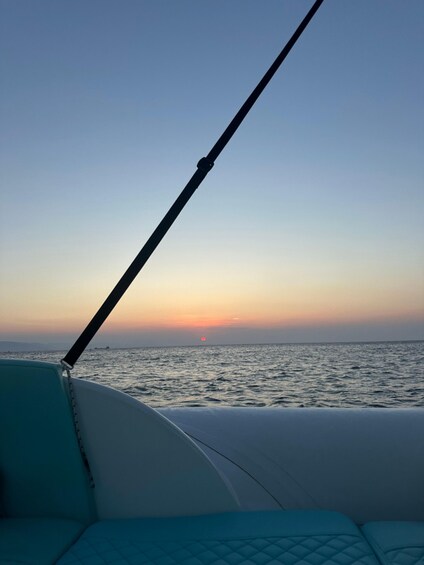 A boat's interior with a view of the sunset over the ocean. 4