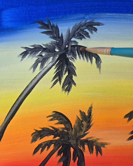 A palm tree with a paintbrush in the foreground against a sunset sky. 4