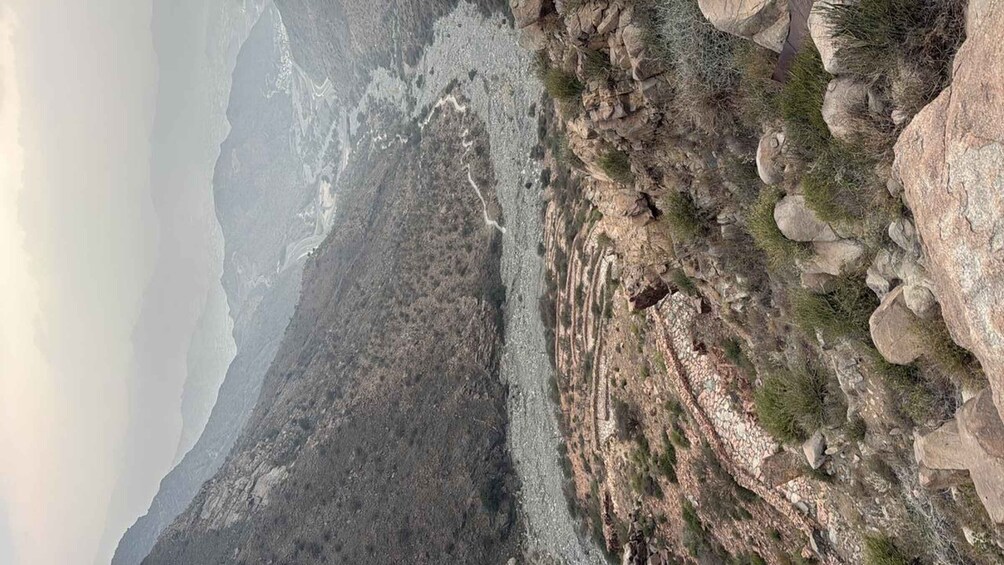 A rugged mountainous landscape with rocky outcrops and sparse vegetation. 4
