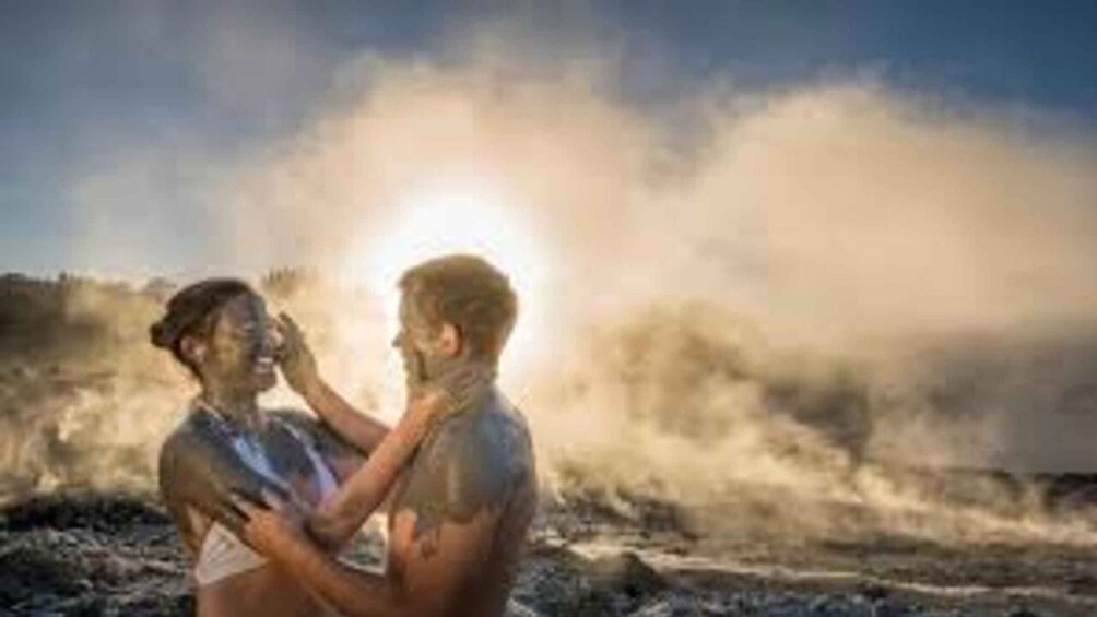 Two people embracing on a beach with waves in the background. 5