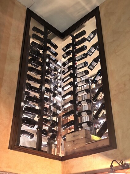 A wine rack with multiple bottles, some labeled 'Alberico.' 4