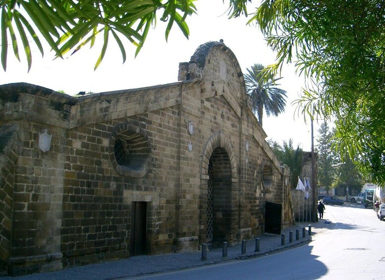 An old stone building with arched doorways and a dome. 3
