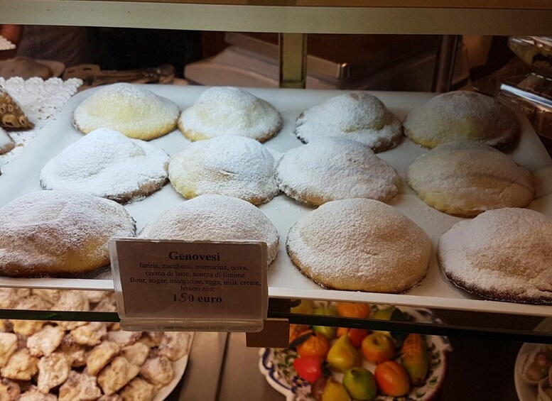 A display of Genovese pastries dusted with powdered sugar, priced at 1.50 euro. 3