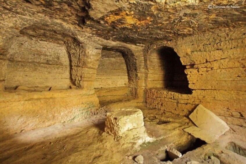 An ancient cave with stone walls and a large opening. 3