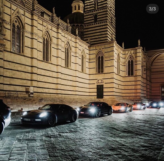 A historic building with arched windows and a dome, illuminated at night. 4