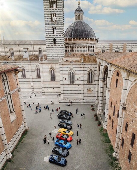 A historic square with a prominent bell tower and a dome, surrounded by classical architecture. 1