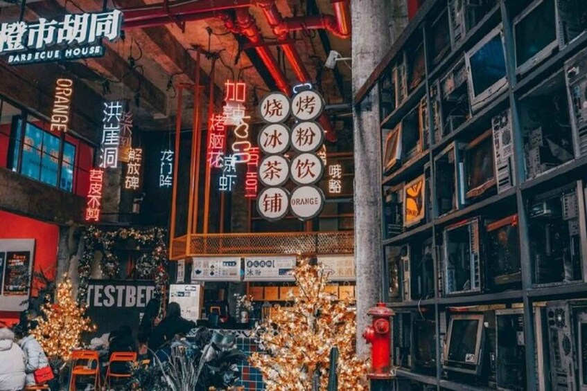 A bar with neon signs and a Christmas tree outside. 2