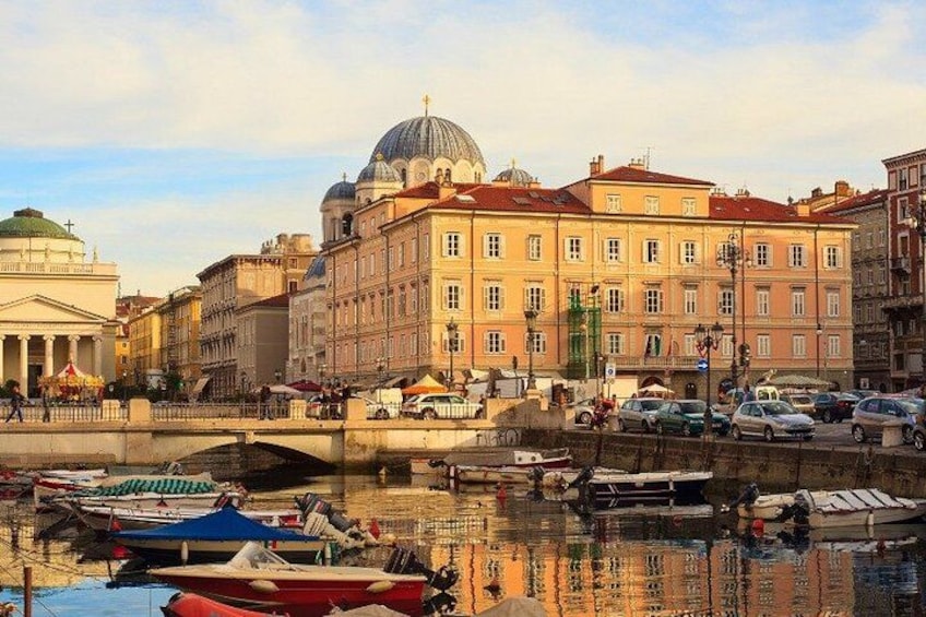A riverside view with a bridge, boats, and historic buildings. 3