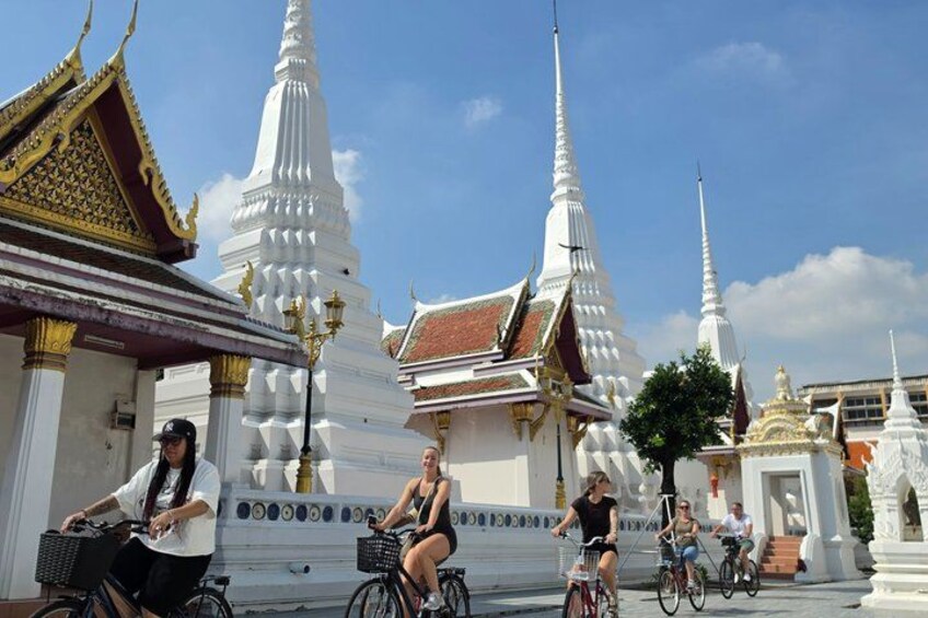 A temple complex with white spires and golden roofs. 1