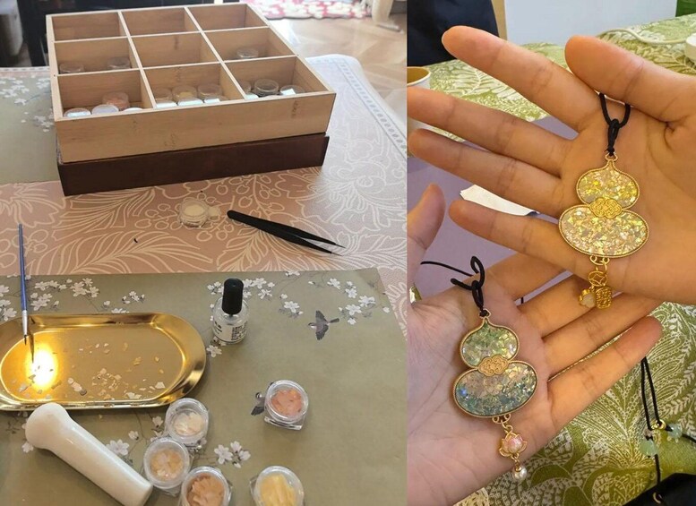 A wooden box with compartments, a mortar and pestle, and small jars of pigments on a patterned surface. 1