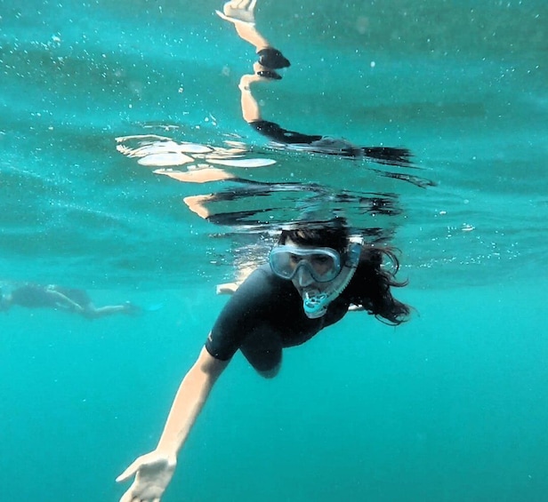 A person swimming underwater. 5