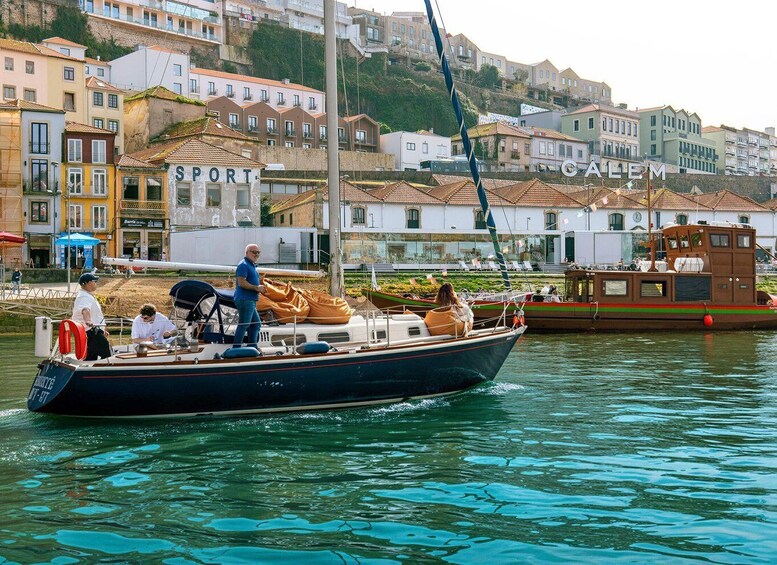 A boat with passengers, docked near buildings with 'SPORT' and 'CALEM' signs. 2