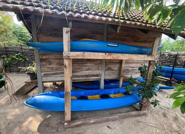 A wooden structure with blue kayaks inside. 3