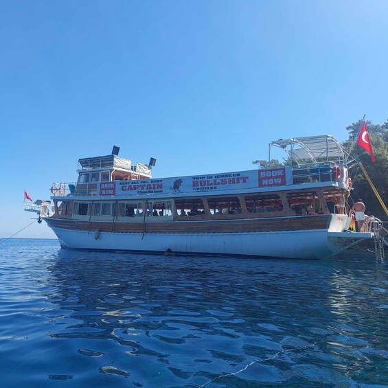 A boat with a 'BOOK NOW' sign, a Turkish flag, and a lifebuoy. 5