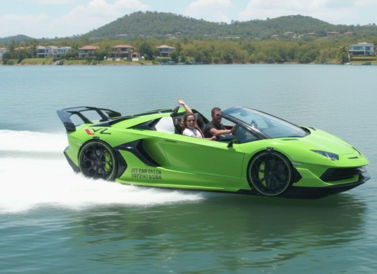 A bright green sports car speeding across a lake with passengers. 1