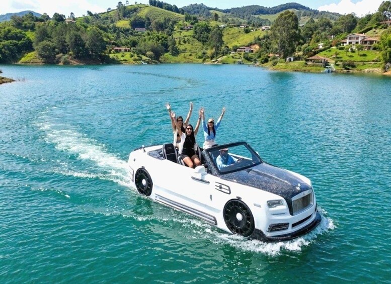 A white convertible boat on a lake surrounded by greenery. 5