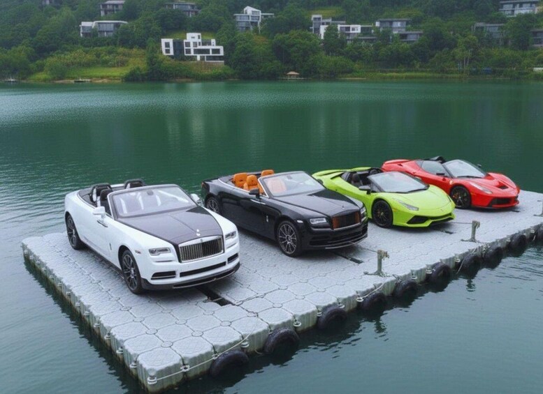 Luxury cars parked on a dock by a lake with houses in the background. 3