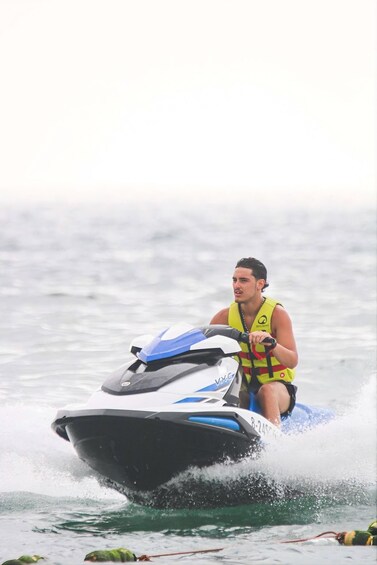 A person riding a jet ski on water. 2