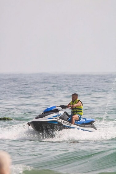 A person riding a jet ski on water. 4