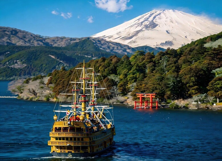 A yellow ship with a red torii gate and a snow-capped mountain in the background. 4