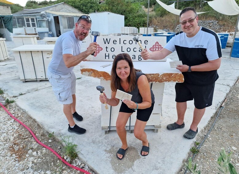 Three people at a construction site with a sign that reads 'Welcome to Local Heritage.' 5