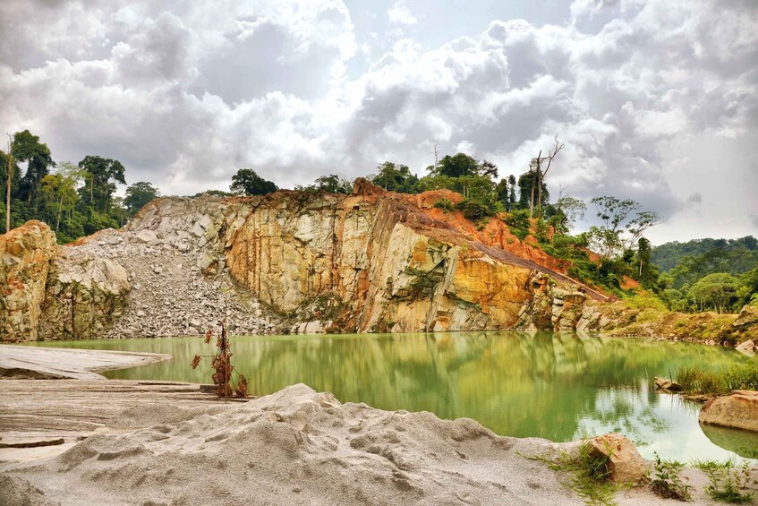 A calm lake surrounded by rocky cliffs and greenery. 3