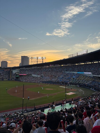 A baseball stadium filled with spectators during a game. 3